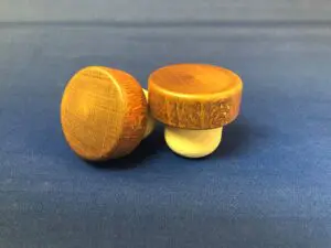 Two Pecan Brown 40x15/27 knobs on a blue background.