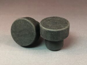 A pair of Black BGD 34x14/22.5 knobs on a gray surface.