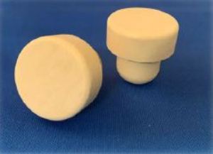 Two Beige BGD 30x12/19.5 plastic knobs on a blue surface.
