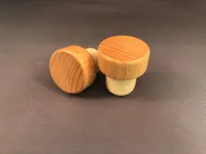 Two Natural Varnished 29x13/19.5 wine stoppers on a grey surface.